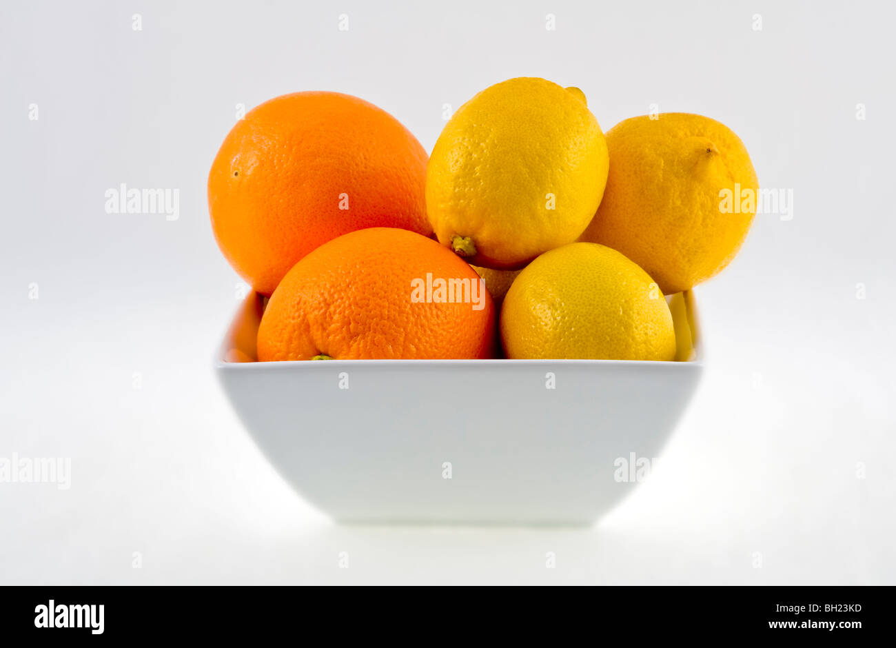 bowl of lemons and oranges on white background Stock Photo - Alamy