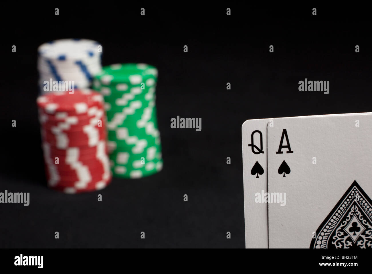 spades ass and queen with green, white and red poker chips Stock Photo -  Alamy