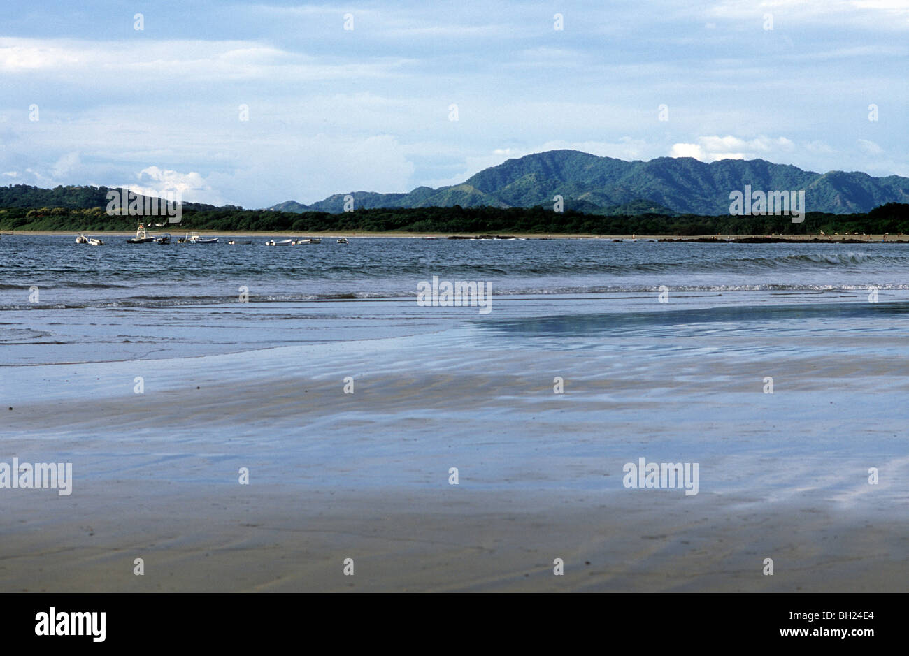 Playa Tamarindo, Costa Rica with rain forest and mountains in