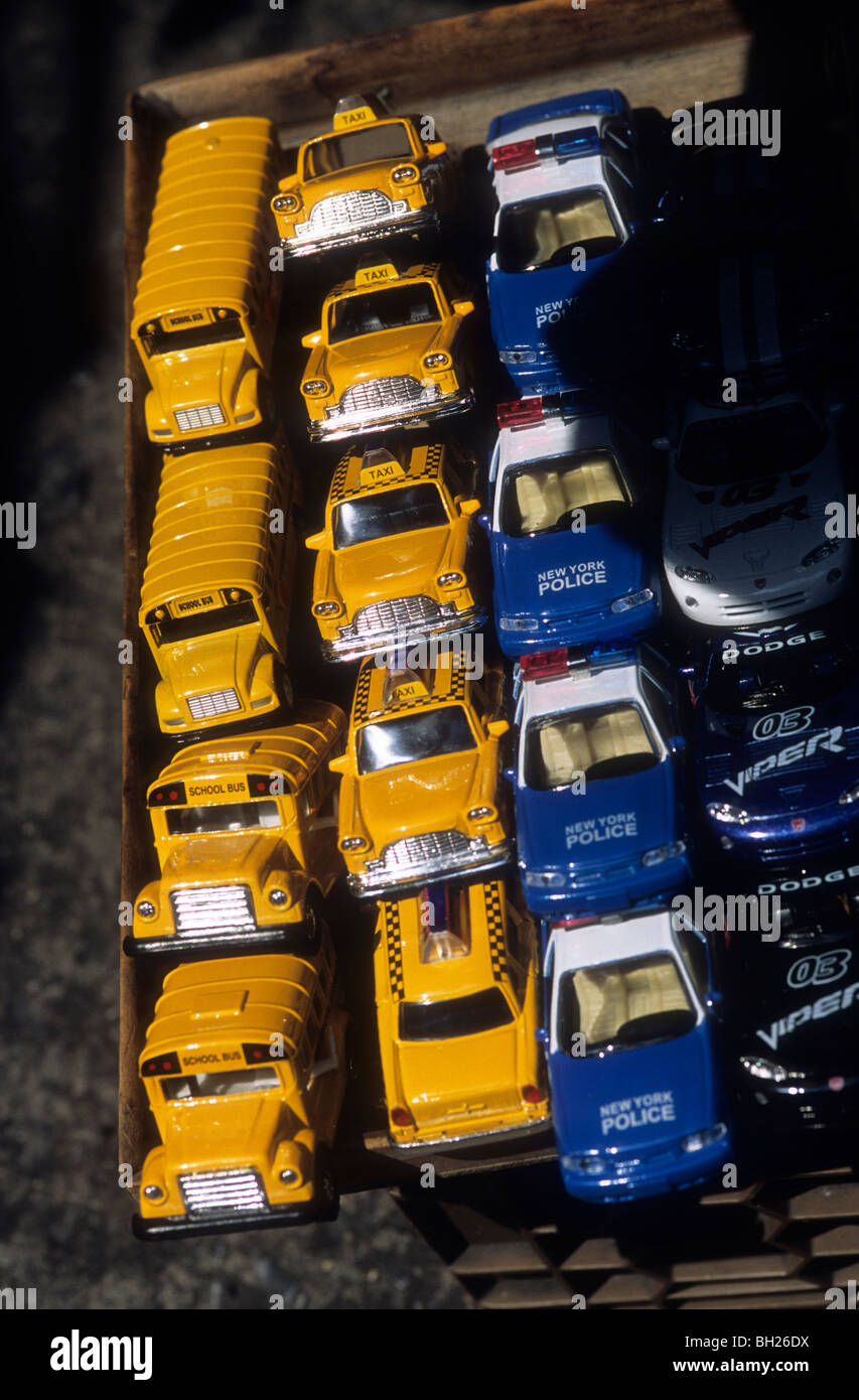 Line up of toy school buses, taxi cabs and police cars in New York Stock Photo