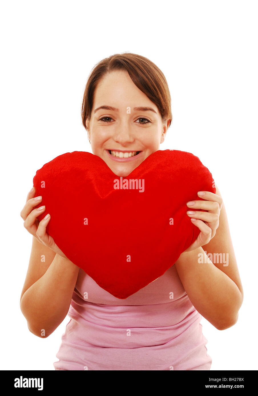 Girl holding heart shaped pillow Stock Photo Alamy