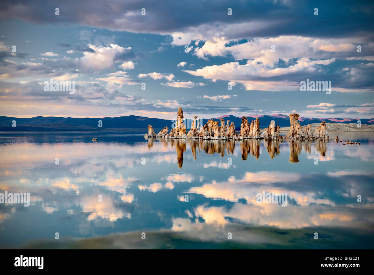 Tufa and cloud reflections in Mono Lake, California Stock Photo
