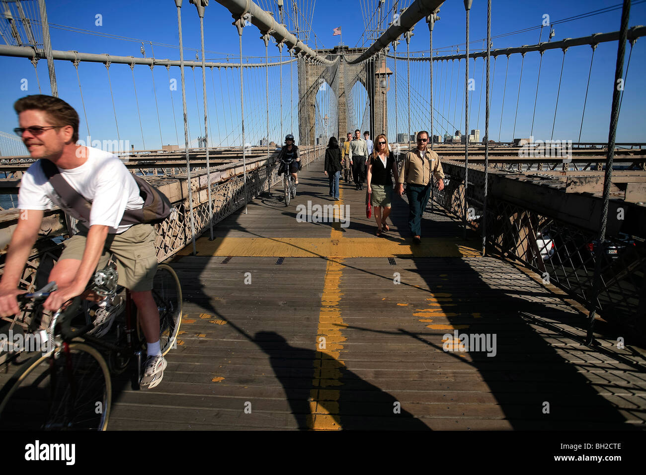 View of the Brooklyn Bridge Night and Days where people walk or ride across the East river to Manhattan Stock Photo