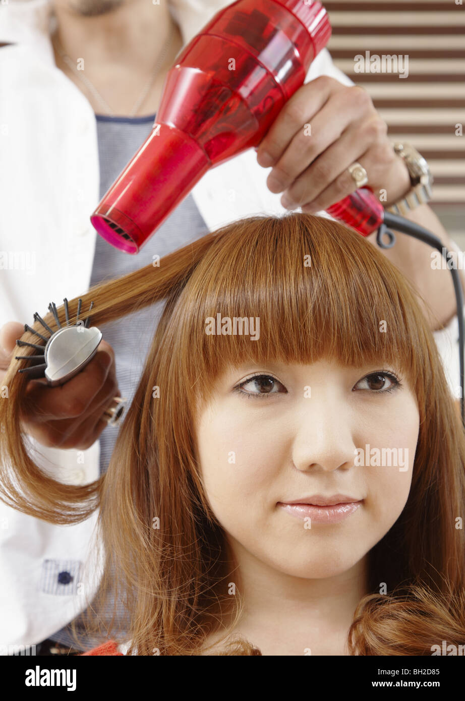 A young woman is blown her hair Stock Photo - Alamy