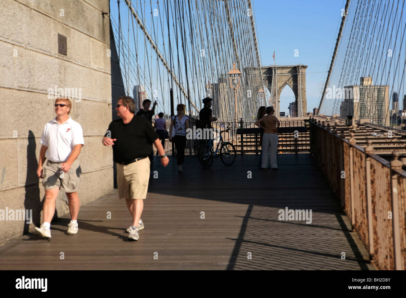 View of the Brooklyn Bridge Night and Days where people walk or ride across the East river to Manhattan Stock Photo