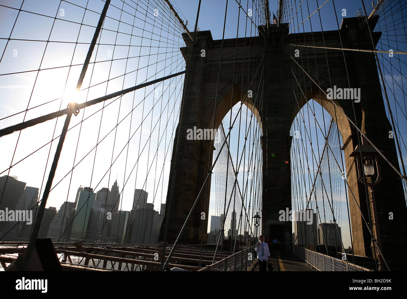 View of the Brooklyn Bridge Night and Days where people walk or ride across the East river to Manhattan Stock Photo