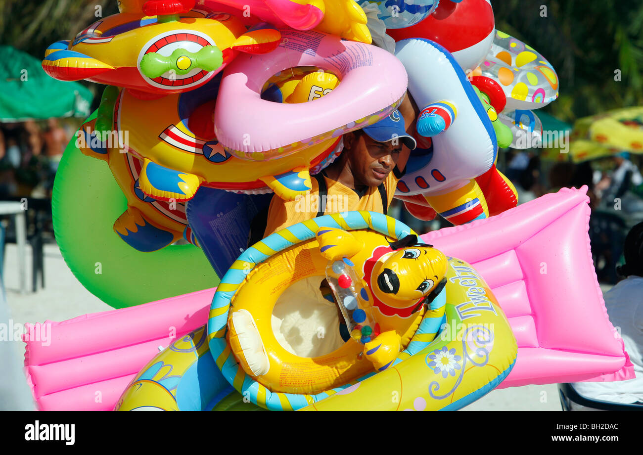 A man selling beach toys at the beach in Boca Chica, Dominican Republic