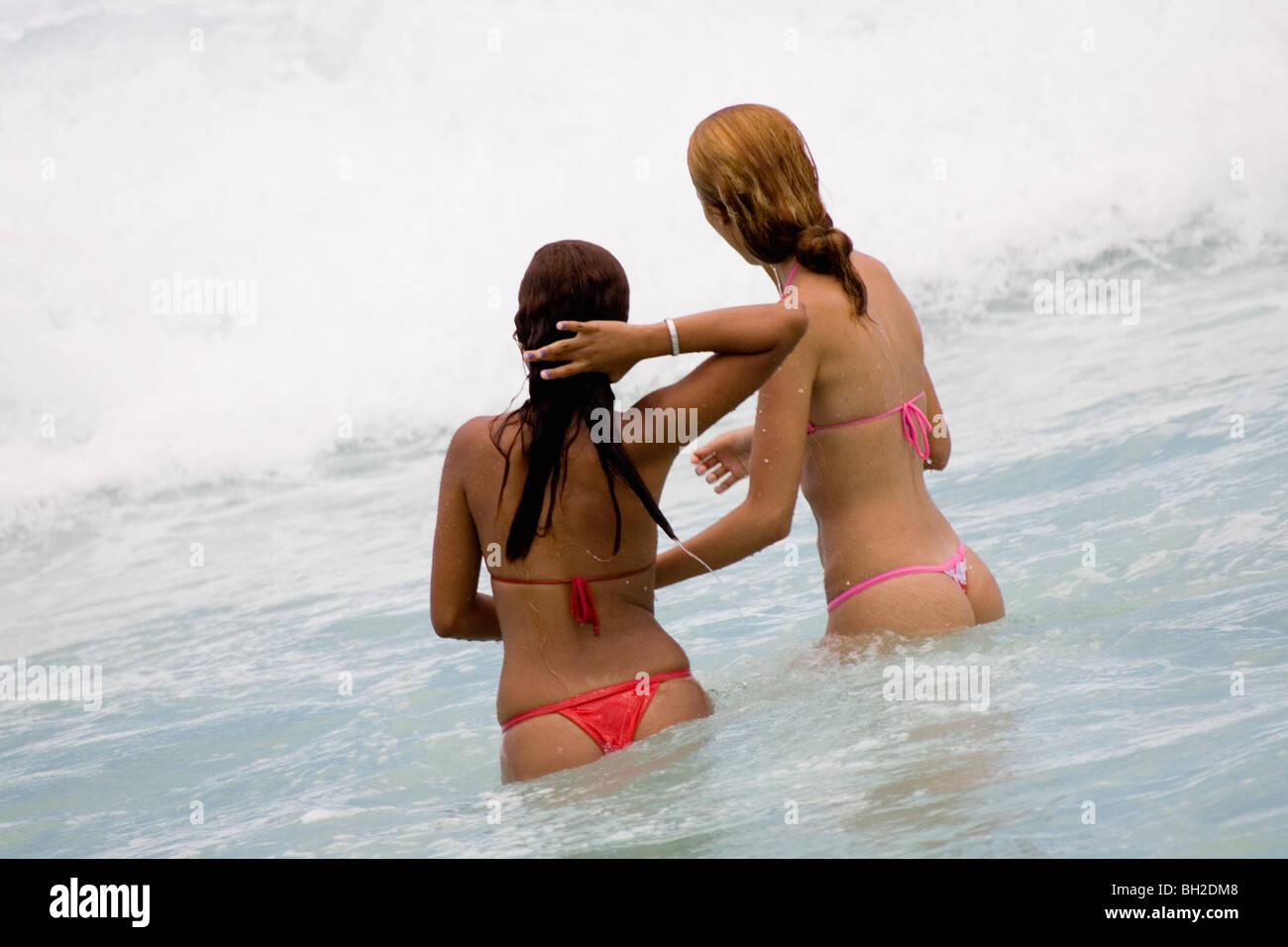 Young Brazilian girls playing in the surf on Copacabana Beach in Rio de Janeiro in Brazil Stock Photo