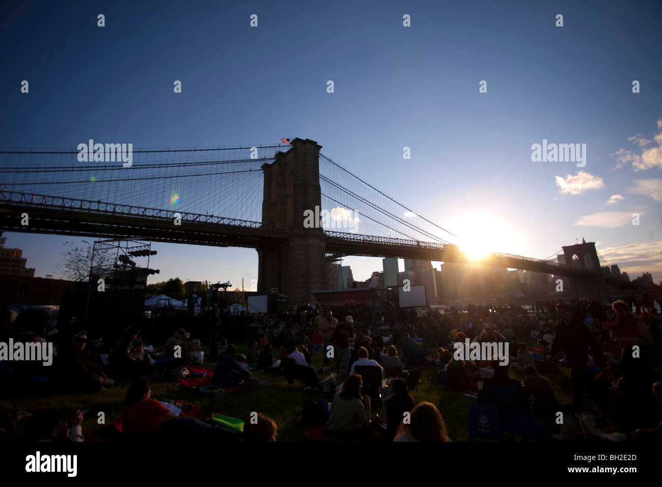 View of the Brooklyn Bridge Night and Days where people walk or ride across the East river to Manhattan Stock Photo