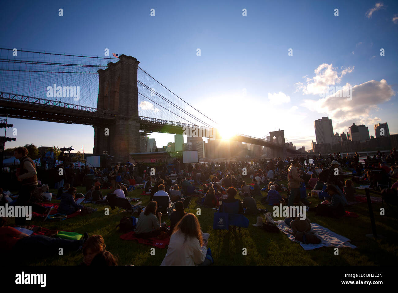 View of the Brooklyn Bridge Night and Days where people walk or ride across the East river to Manhattan Stock Photo