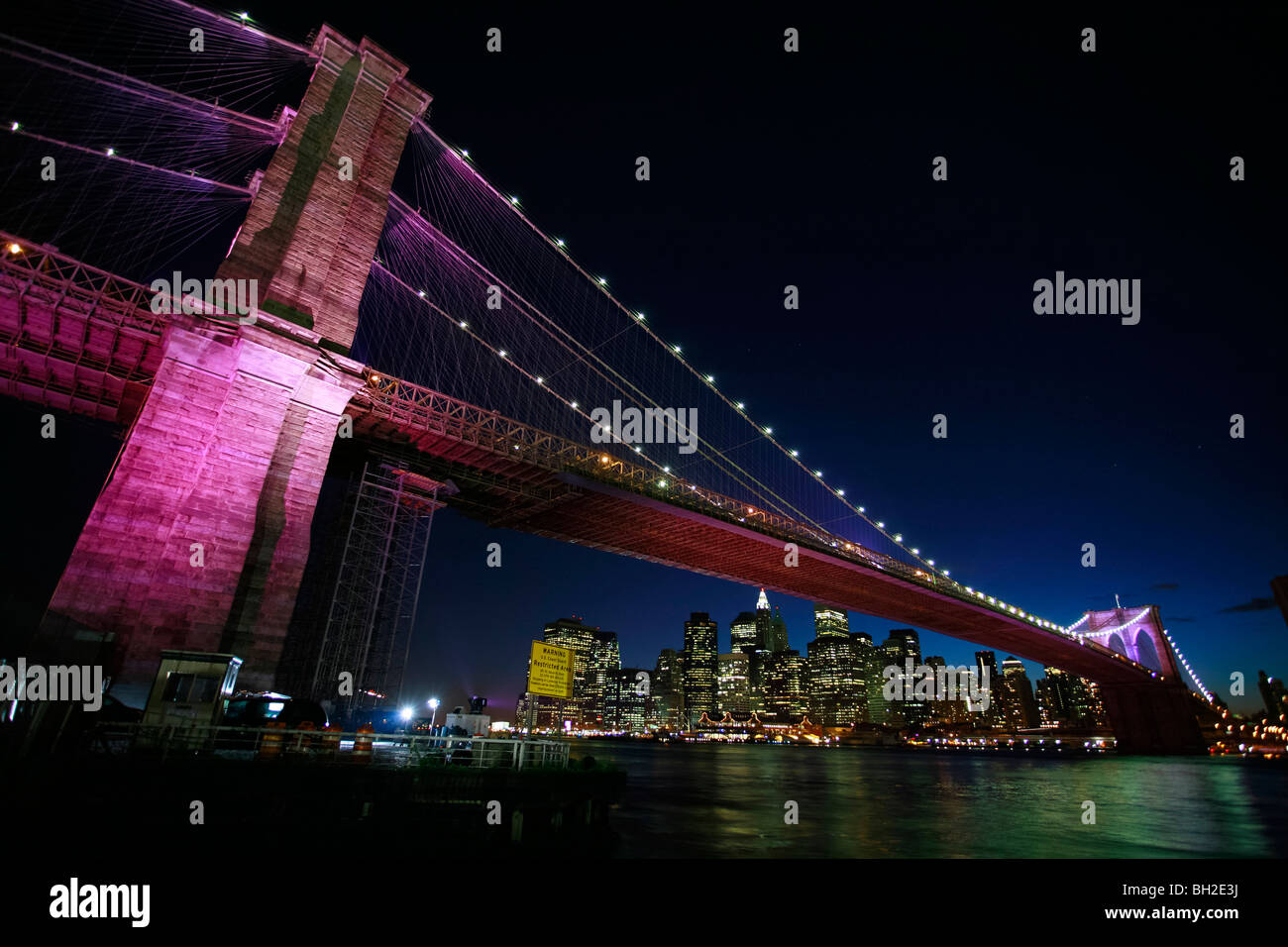 View of the Brooklyn Bridge Night and Days where people walk or ride across the East river to Manhattan Stock Photo