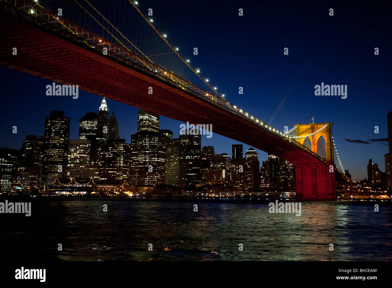 View of the Brooklyn Bridge Night and Days where people walk or ride across the East river to Manhattan Stock Photo