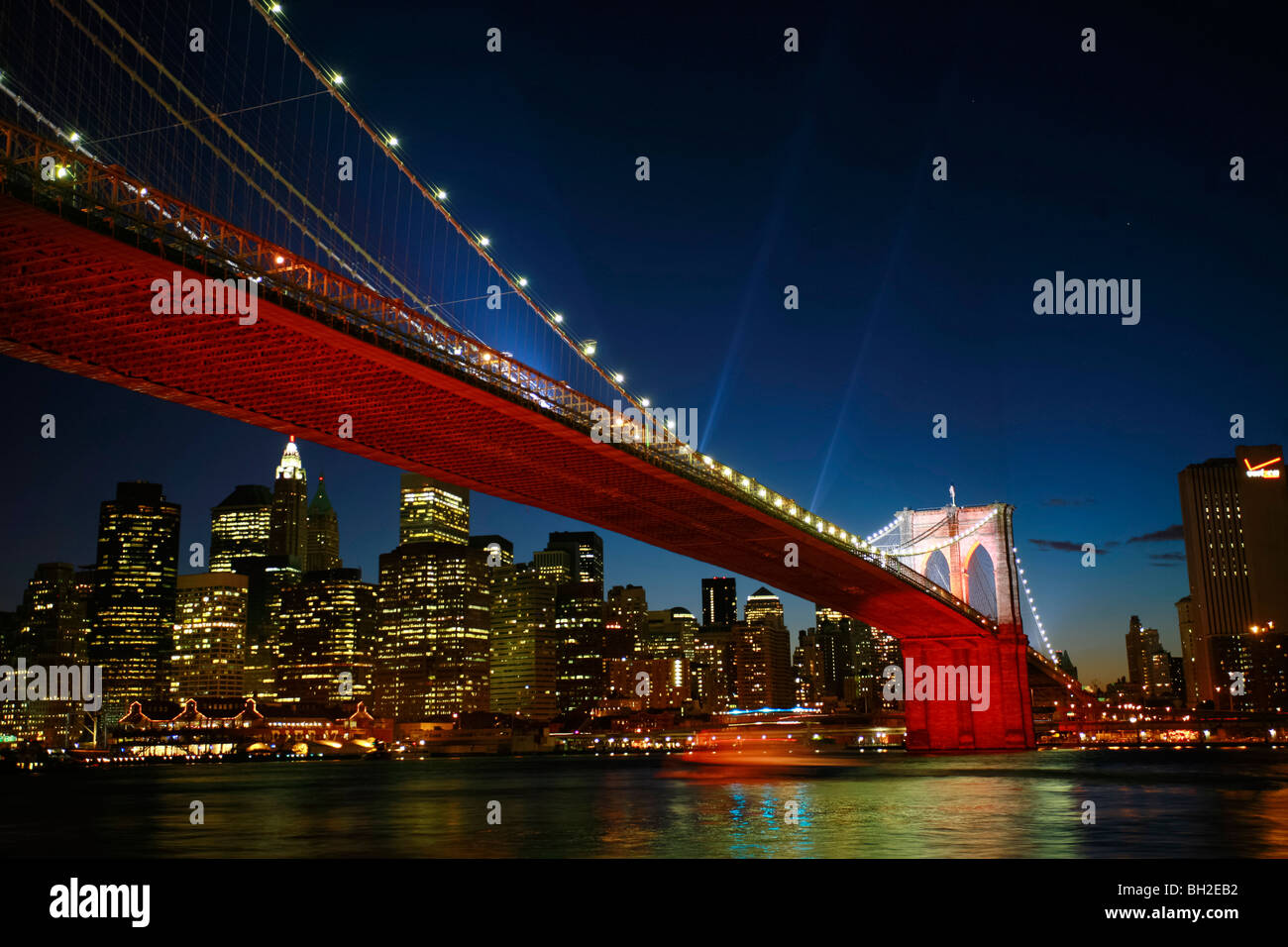 View of the Brooklyn Bridge Night and Days where people walk or ride across the East river to Manhattan Stock Photo