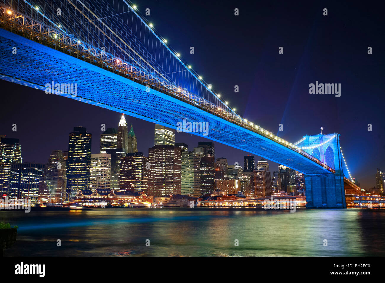 View of the Brooklyn Bridge Night and Days where people walk or ride across the East river to Manhattan Stock Photo