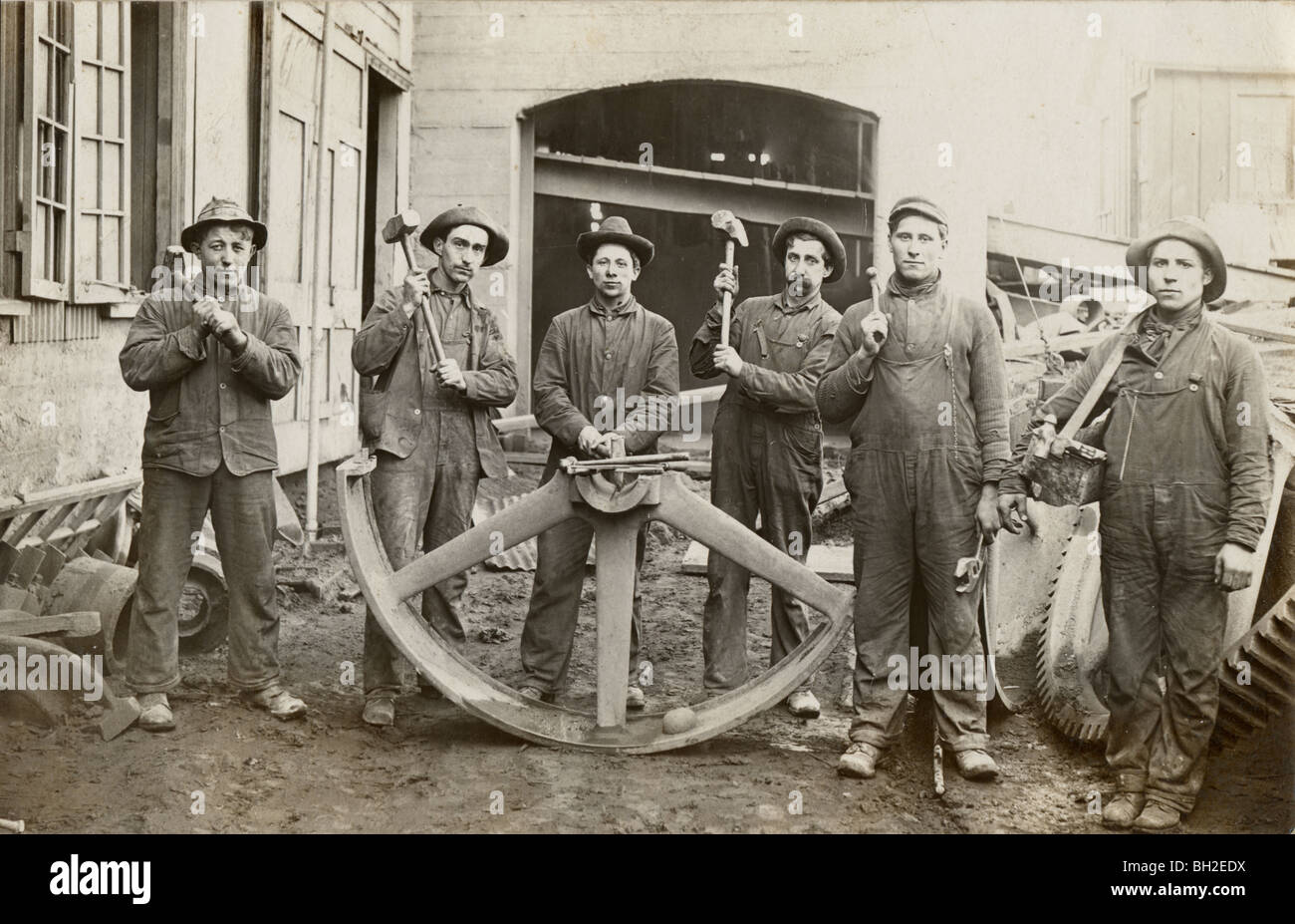 Six Laborers & Half of Giant Industrial Wheel Stock Photo