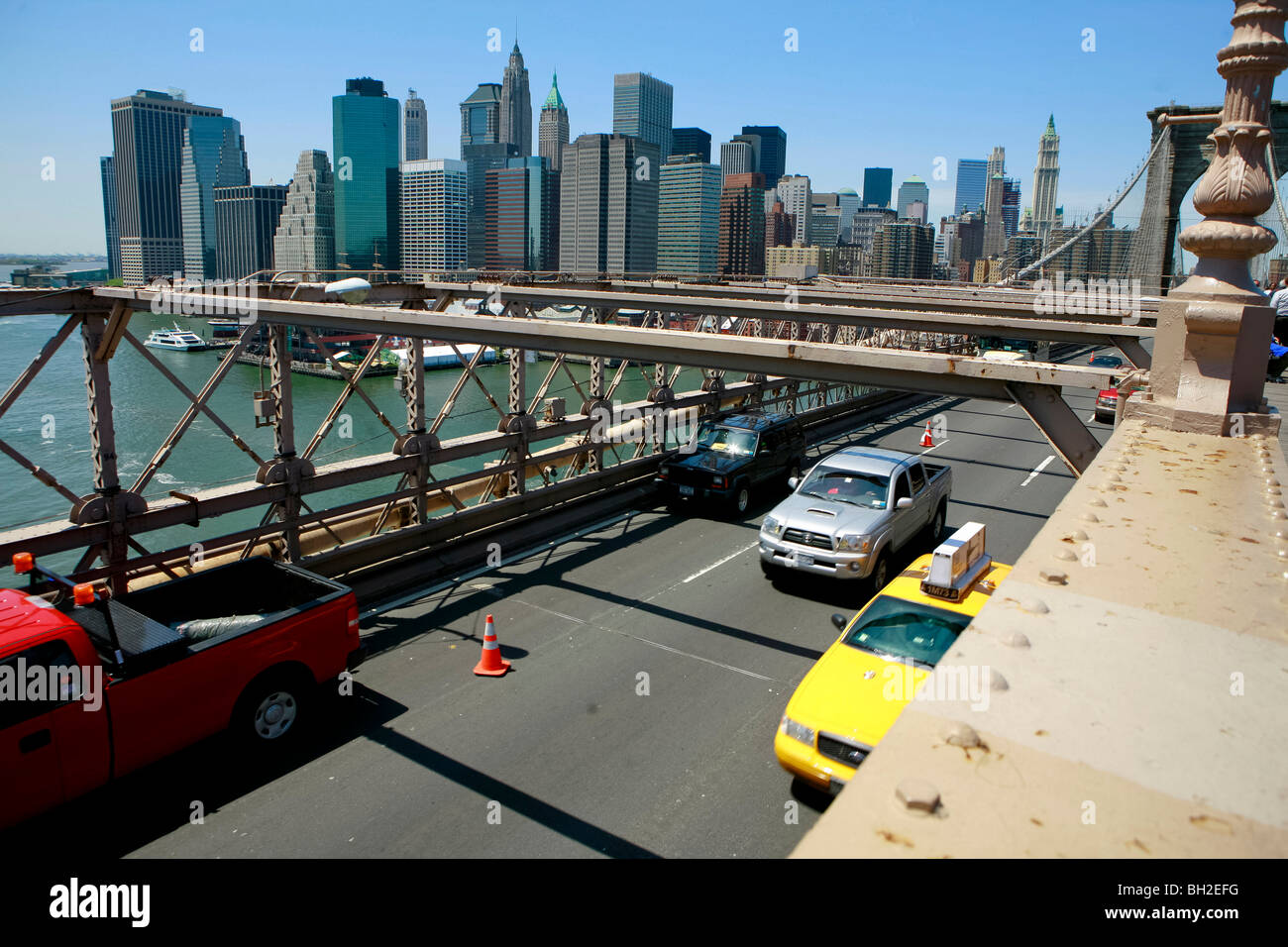 View of the Brooklyn Bridge Night and Days where people walk or ride across the East river to Manhattan Stock Photo