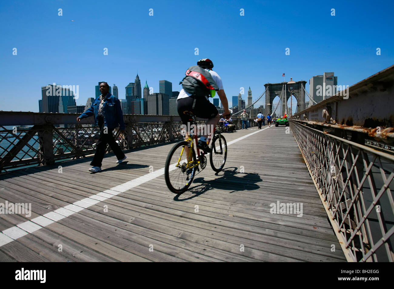 View of the Brooklyn Bridge Night and Days where people walk or ride across the East river to Manhattan Stock Photo