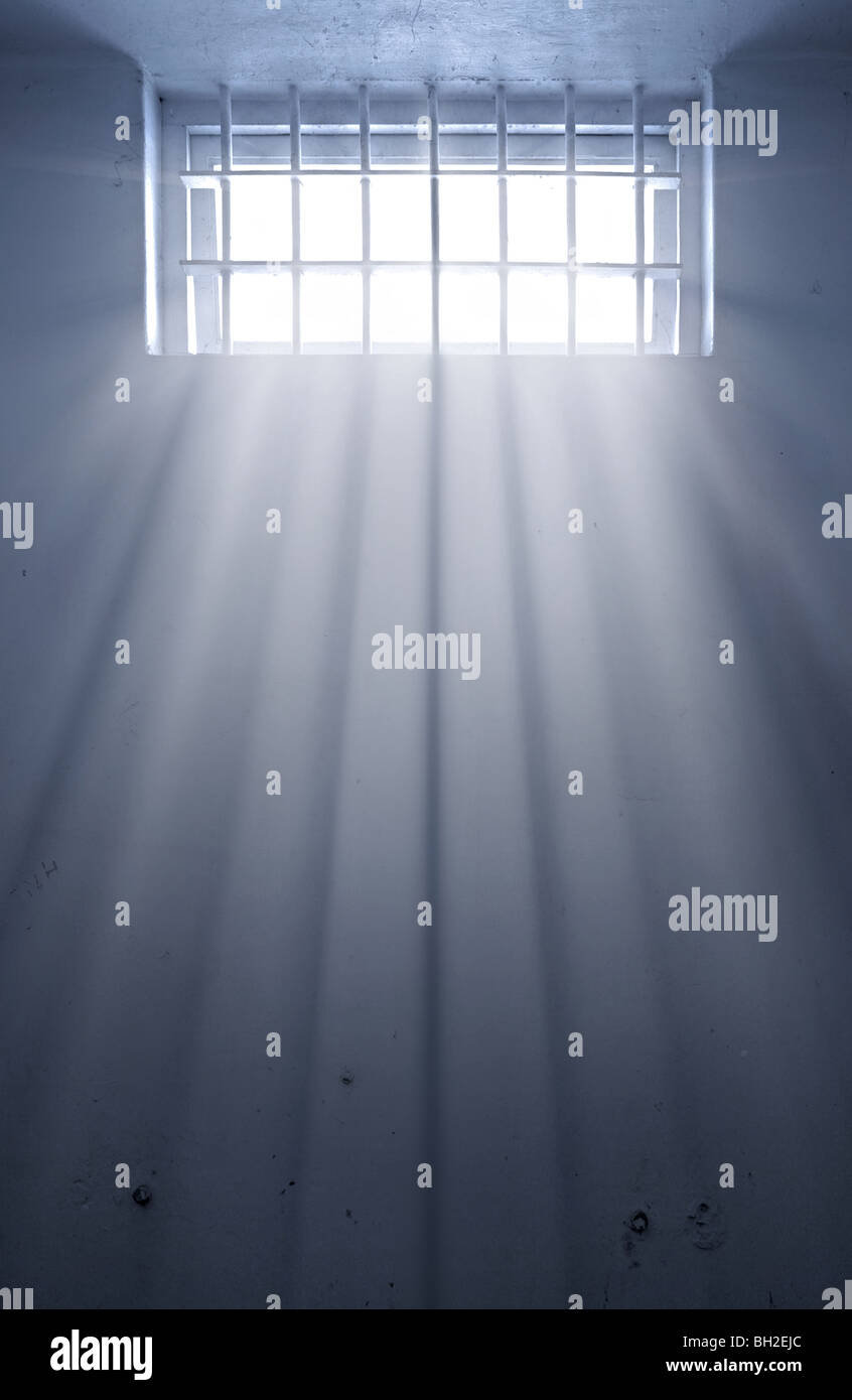 a cold prison cell with sunshine through window Stock Photo