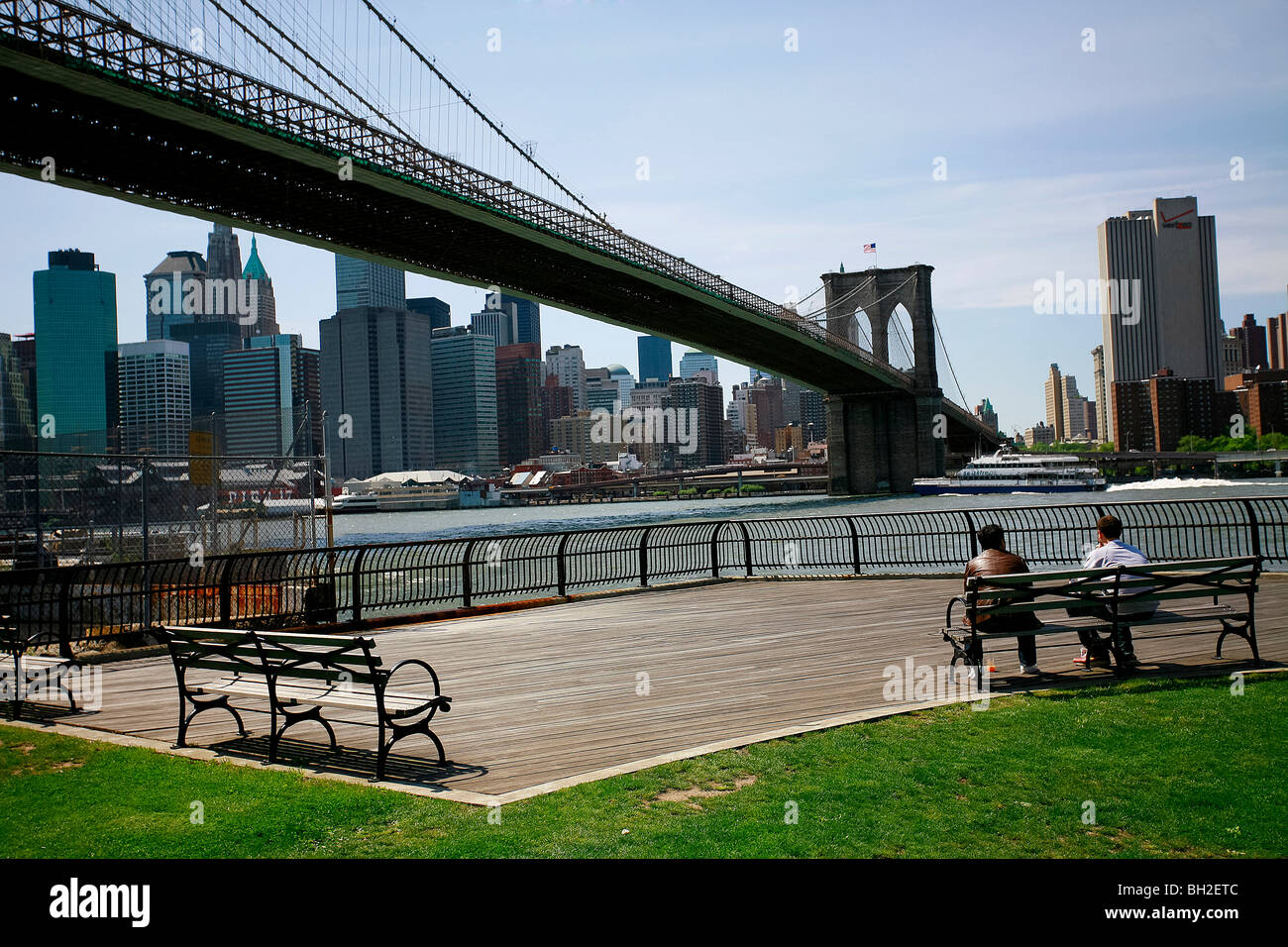 View of the Brooklyn Bridge Night and Days where people walk or ride across the East river to Manhattan Stock Photo