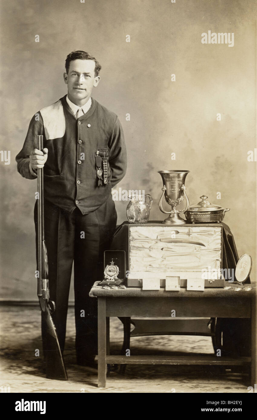 Competitive Shooting Champion Displaying Trophies Stock Photo