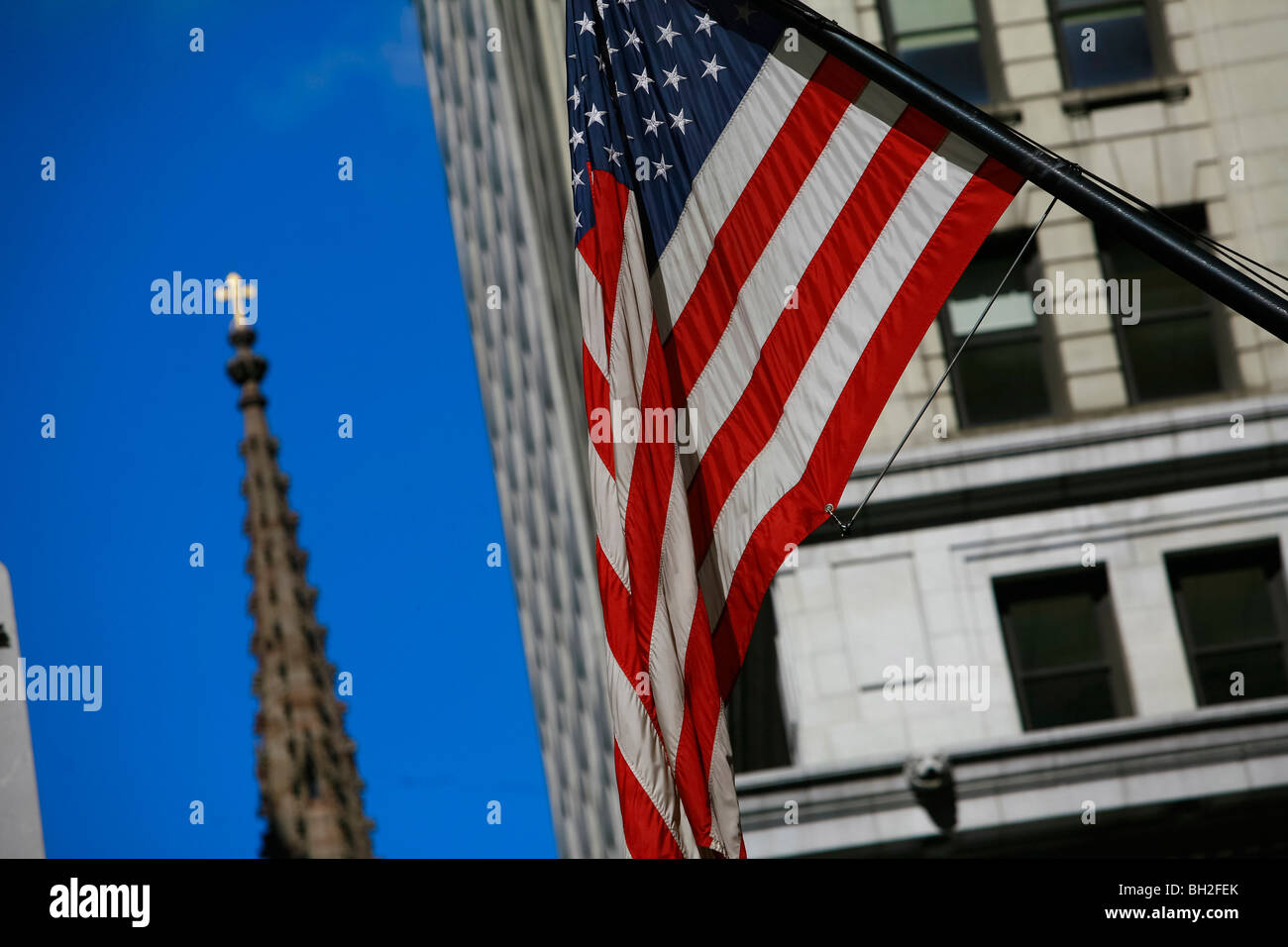 Wall Street and the New York Stock Exchange in New York with a huge American flag Stock Photo