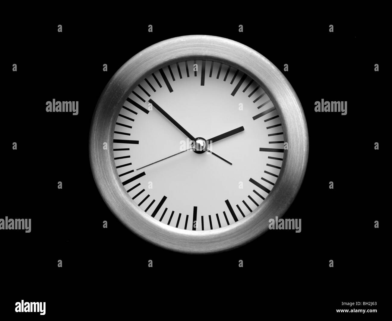 An analogue clock isolated on a black background Stock Photo Alamy