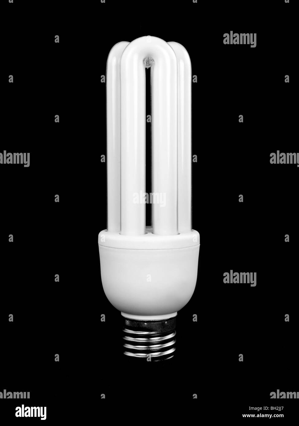 An energy saving light bulb isolated against a black background Stock ...