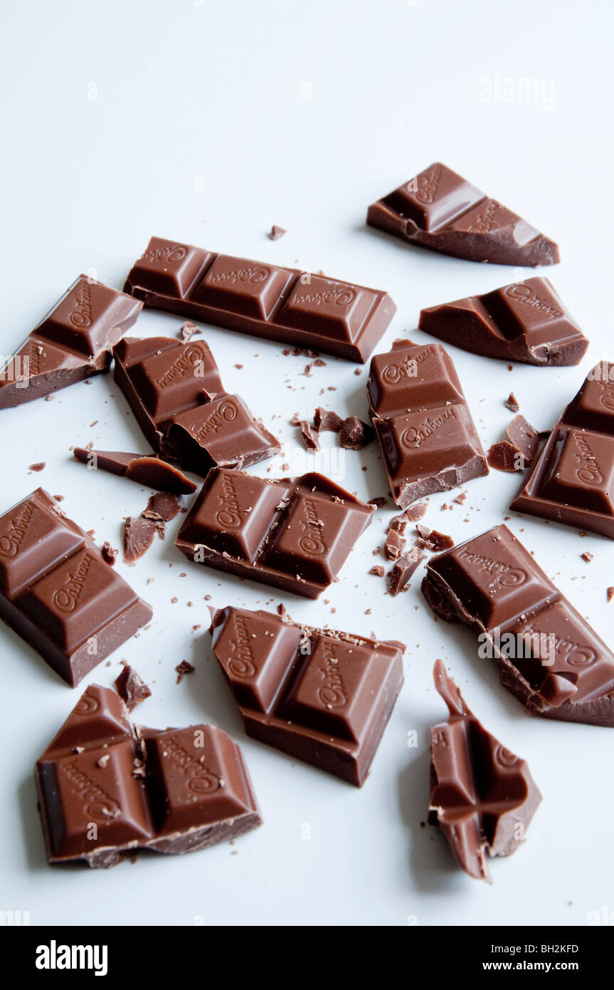 A bar of Cadbury's chocolate broken up into many pieces. Stock Photo