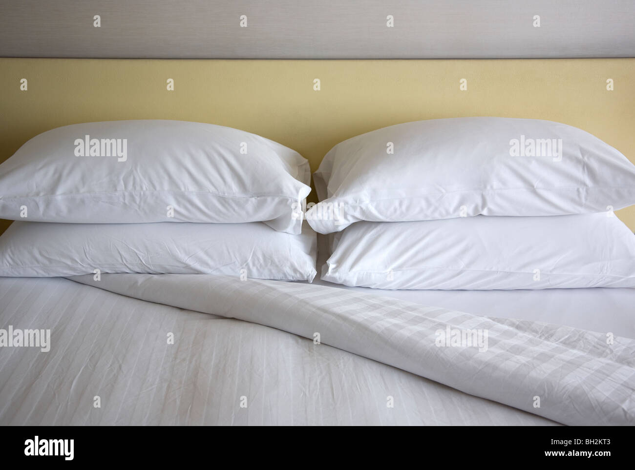 Bed with white linen, turned down Stock Photo