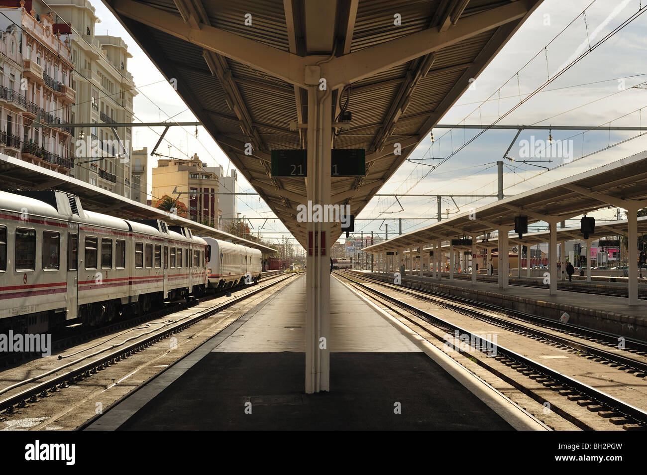 Railroad routes away and empty platform in horizontal position Stock Photo