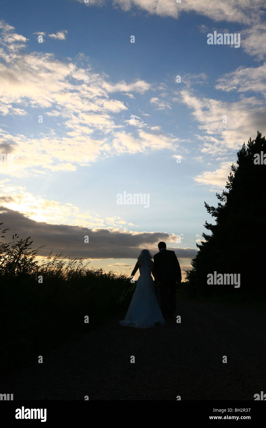 Silhouette of bride and groom against a dramatic sky Stock Photo - Alamy