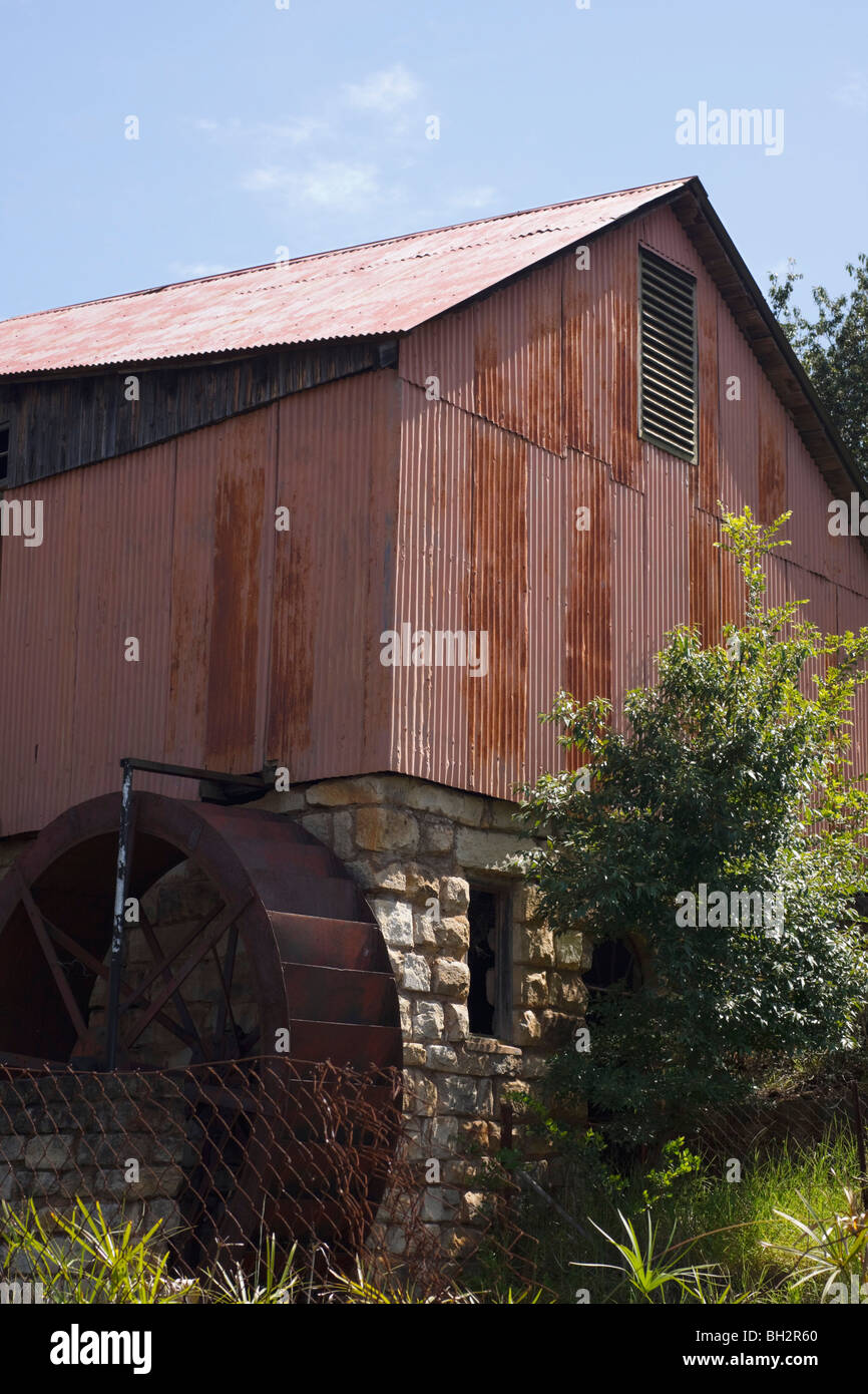 Old steel water wheel on a stone and tin watermill. Kwazulu Natal, South Africa. Stock Photo