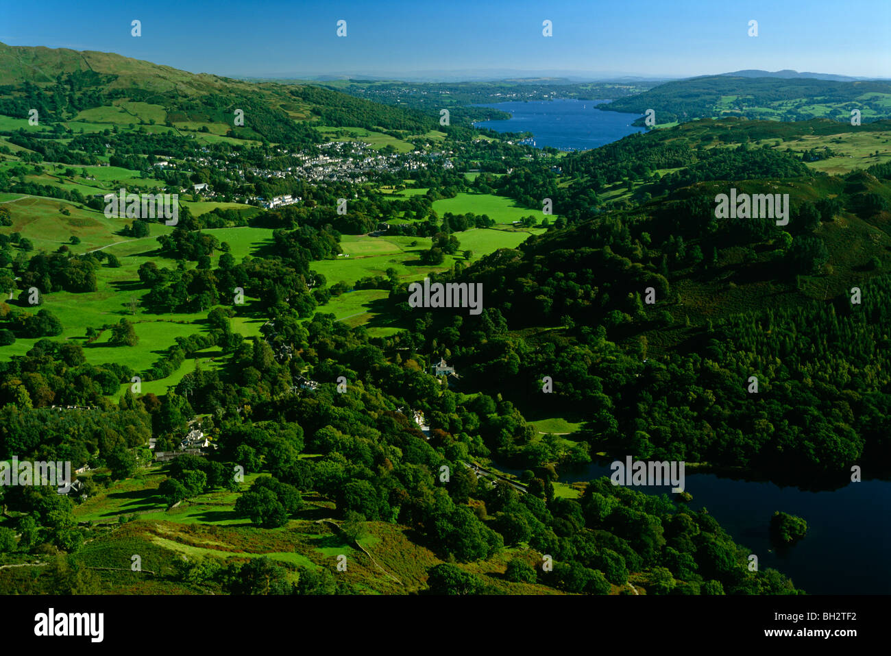 A summer evening view of Rydal Water and Windermere and Ambleside seen from Nab Scar , The Lake District National Park, Cumbria Stock Photo