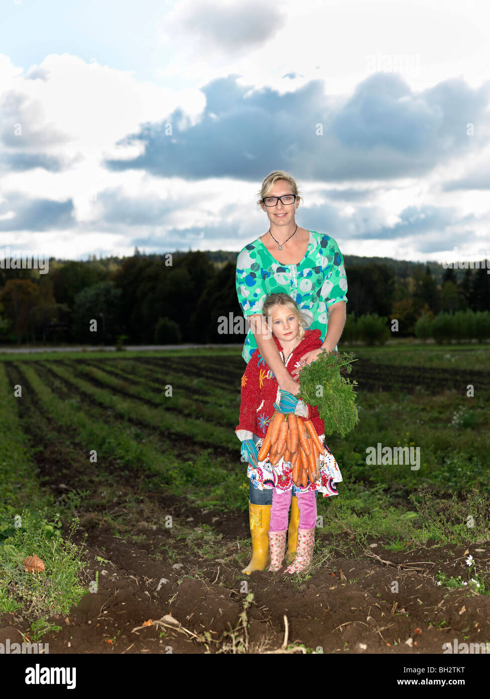 Mother and daughter on field Stock Photo Alamy