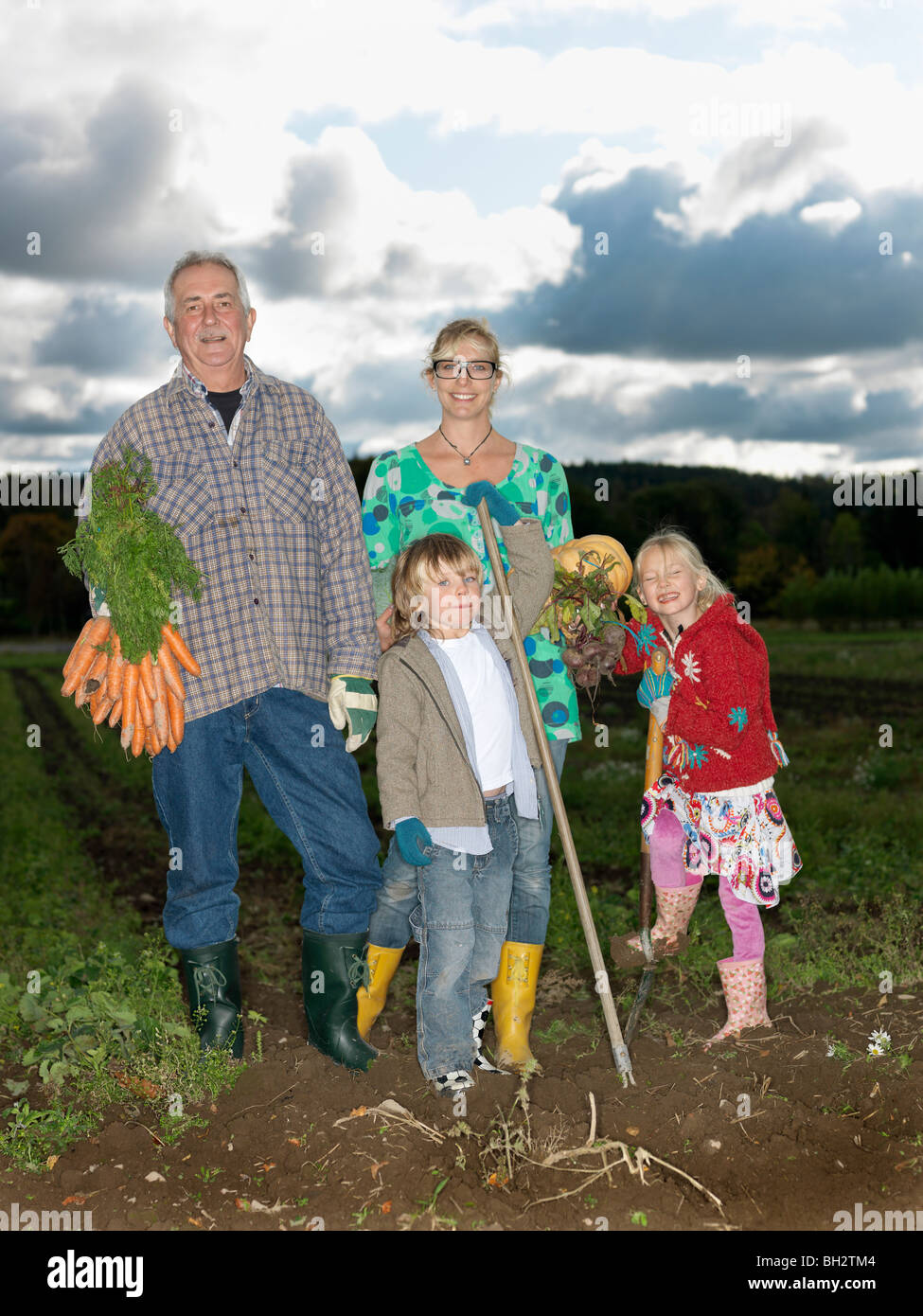 Family in a field Stock Photo - Alamy