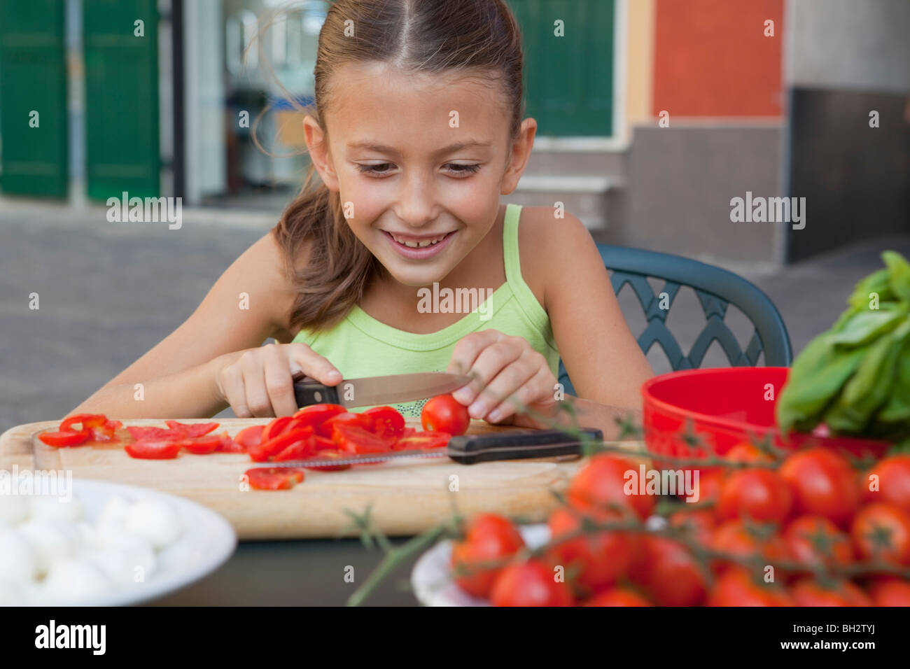 girl cutting tomatoes Stock Photo Alamy