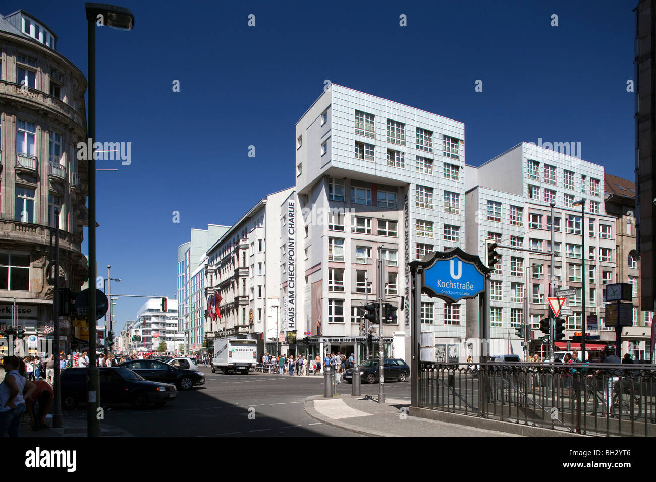 Kochstrasse U-Bahn sign on Friedrichstrasse with the Haus am Checkpoint Charlie Museum on the background, Berlin, Germany Stock Photo