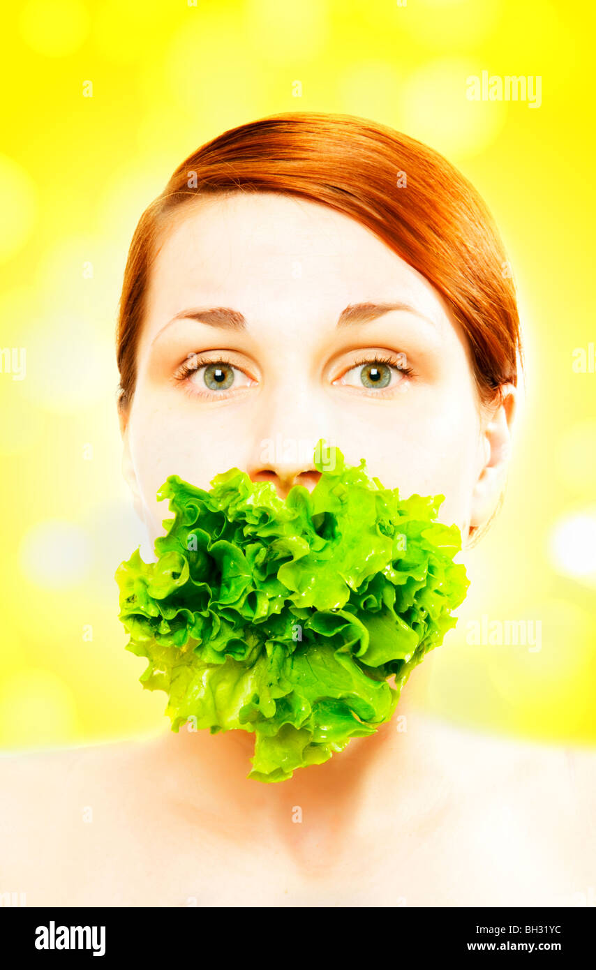 Pretty young woman eating lettuce Stock Photo Alamy