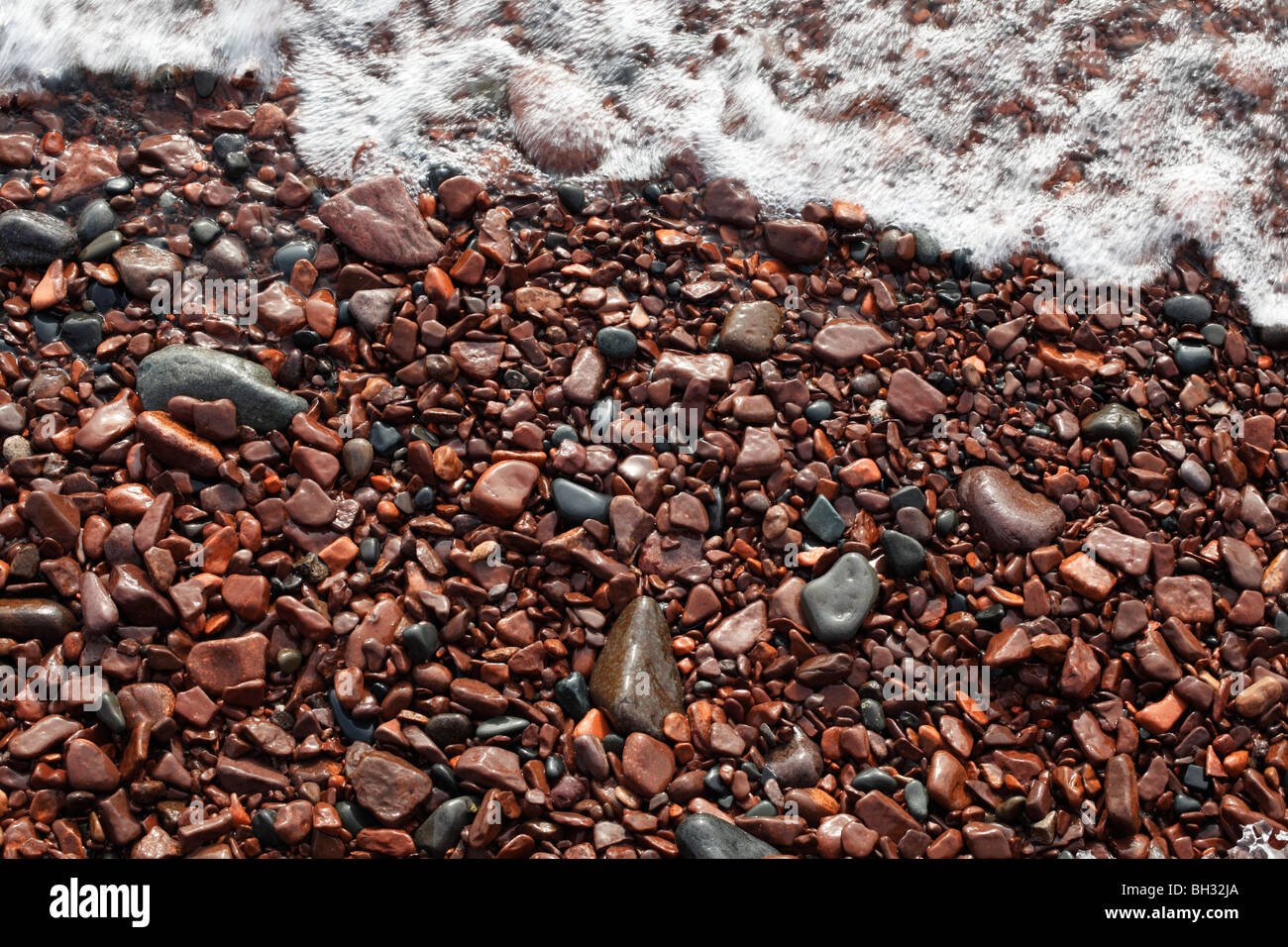 Water washed rocks on the shoreline of Lake Superior in northern Minnesota. Stock Photo