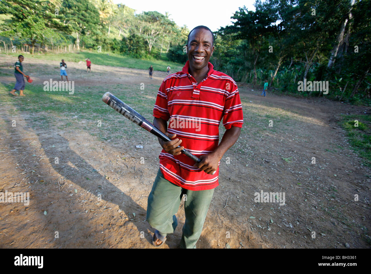 Adult supervisor at a boys informal baseball game, Dominican Republic Stock Photo