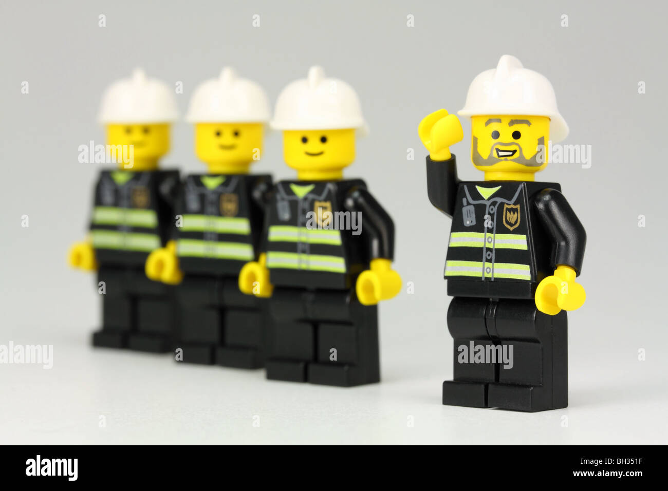 Lego fire chief and crew of firemen Stock Photo