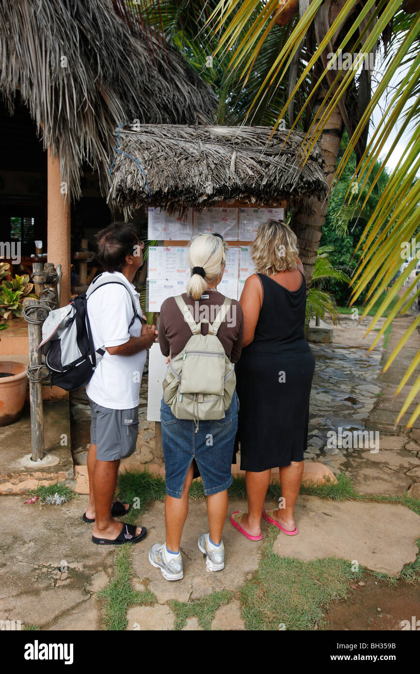 Tourists check a restaurant menu, Las Galeras, Samana peninsula, Dominican Republic Stock Photo