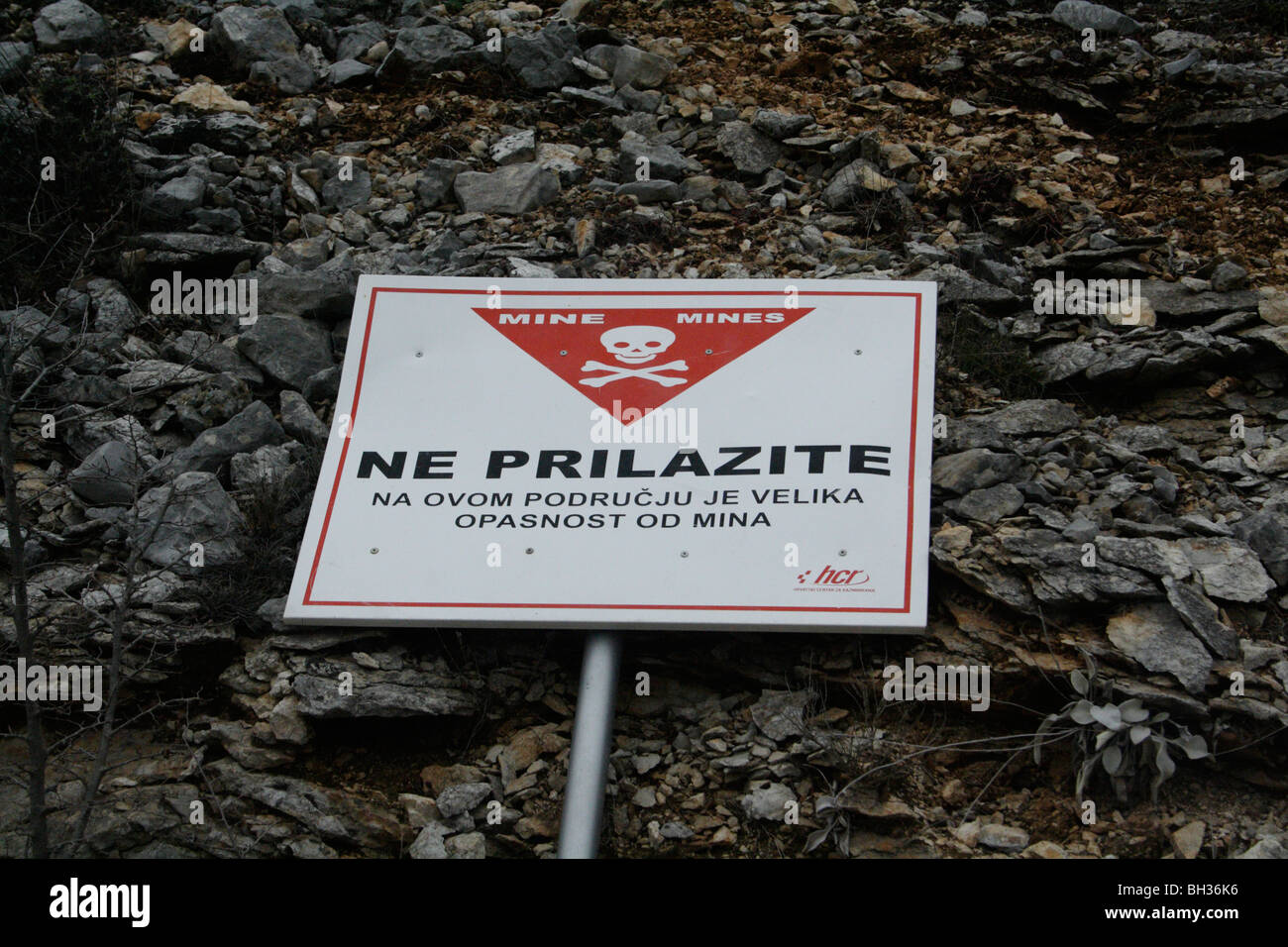 Sign 'Warning Land Mines' in Croatian language found in the former war zone on the Croatian-Bosnian border Stock Photo