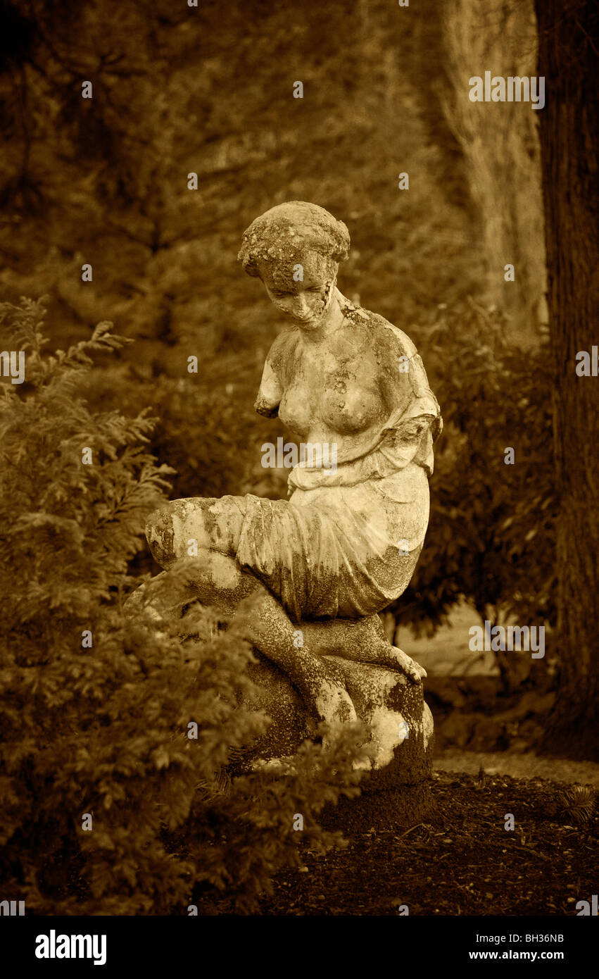 At the Harrison Hot SpringsResort, in British Columbia, Canada, a nice little garden area has some statuary tucked in the forest Stock Photo