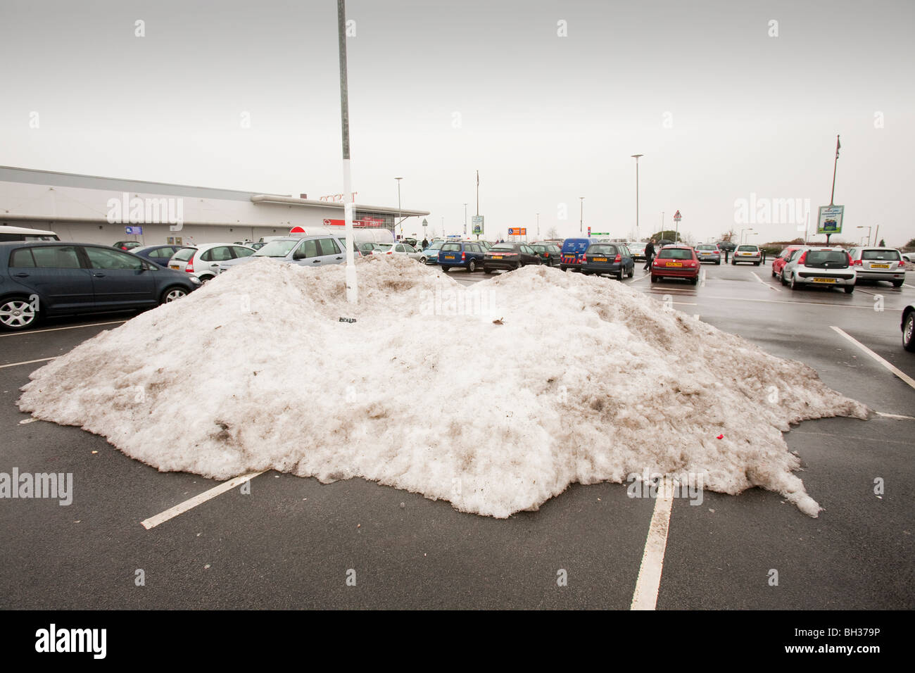 Piles of snow from Decembers heavy snowfall in Tesco carpark in Oldham