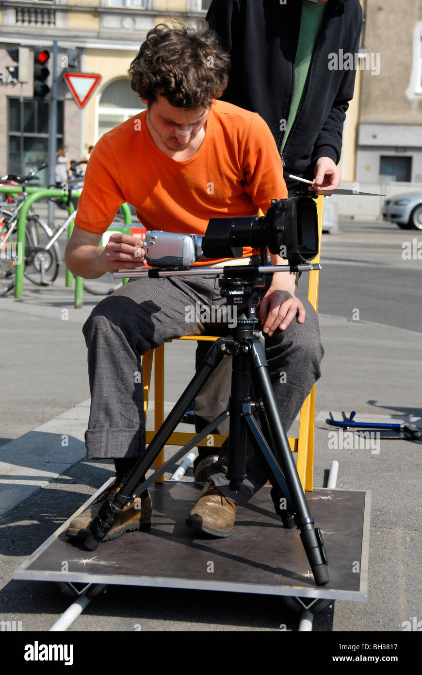 Low budget film shooting, cameraman on dolly, Vienna, Austria, Europe Stock Photo