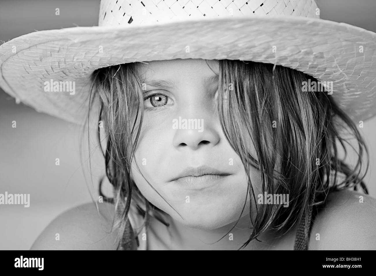 Black and White Shot of a Pretty Child in Summer Hat Stock Photo