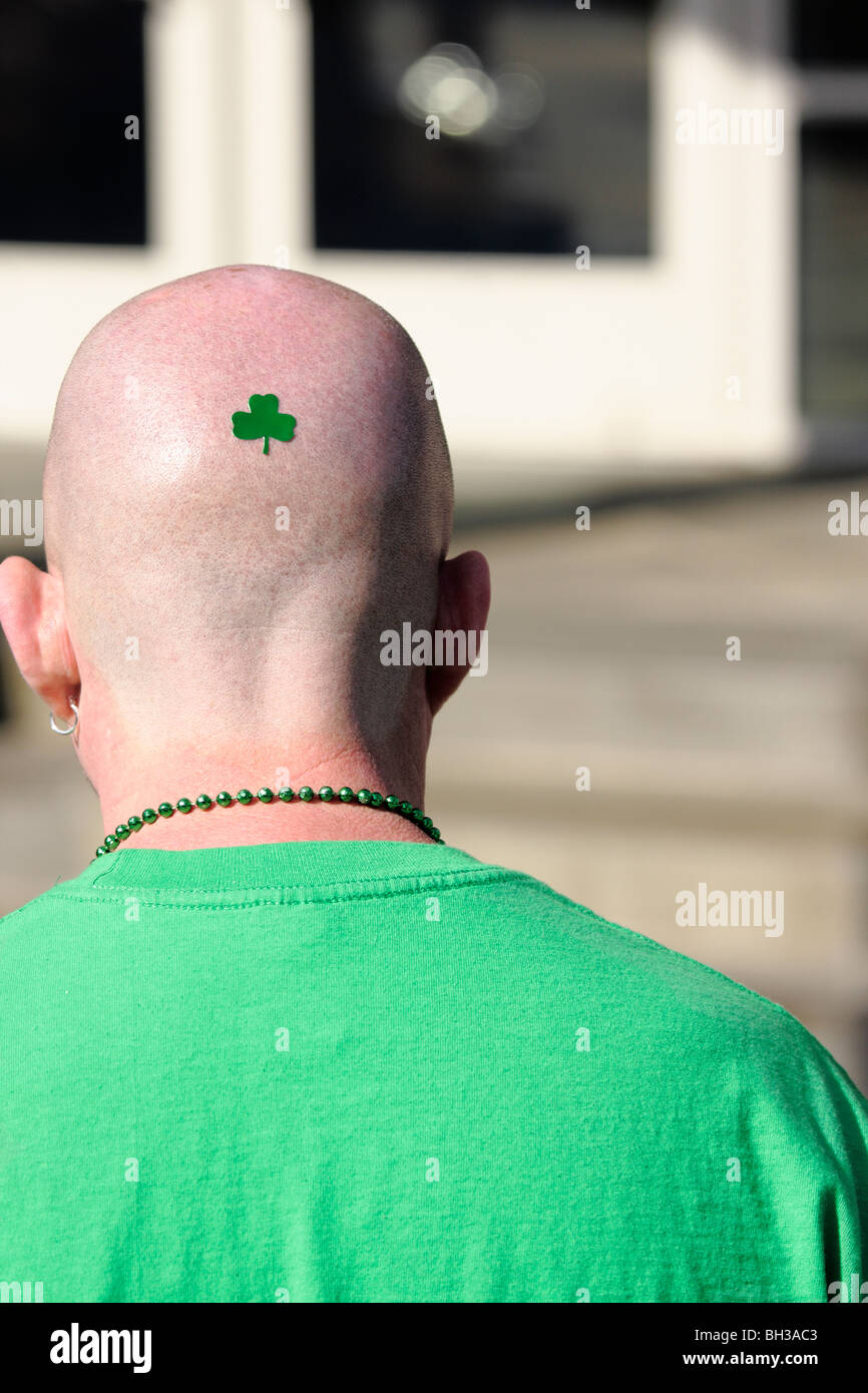 Man with shamrock decal on his head at St. Patrick's Day celebration, USA Stock Photo