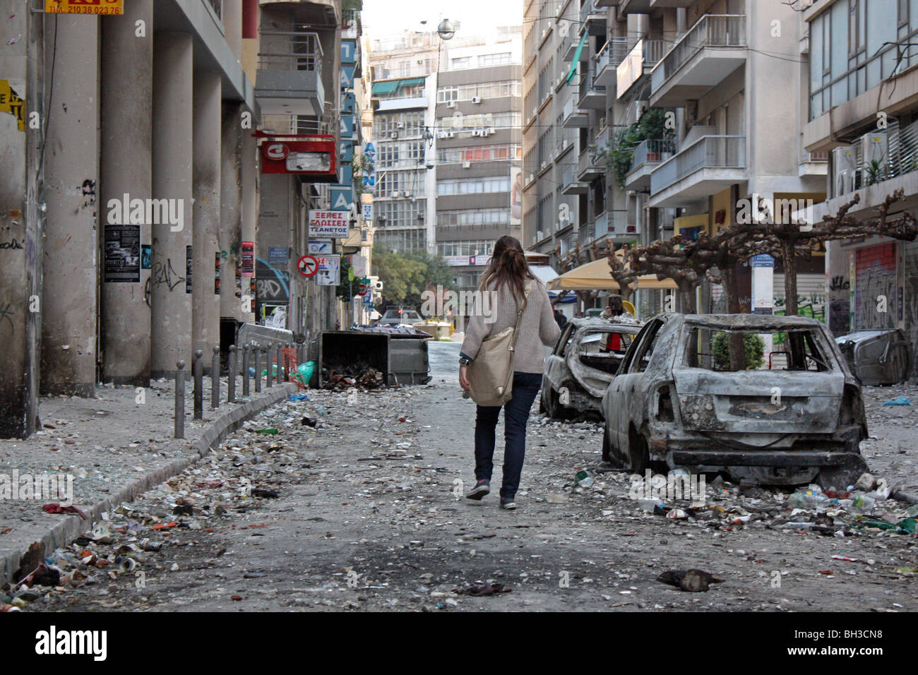 RIOTS IN ATHENS, WOMAN WALKING IN THE STREETS FOLLOWING THE RIOTS ...