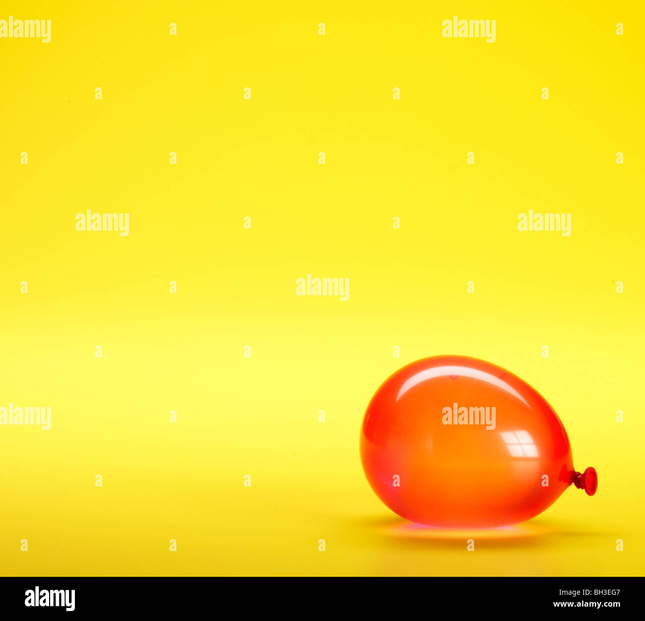 Orange balloon on yellow background Stock Photo